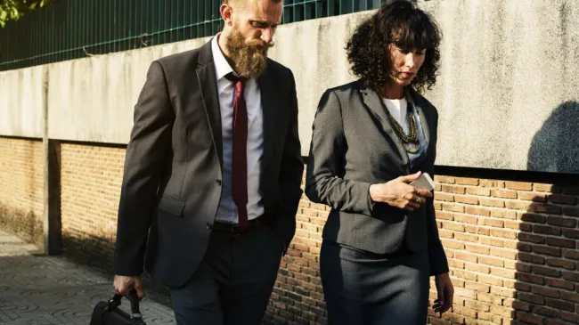 two-business-people-talking-while-on-a-walk.jpg